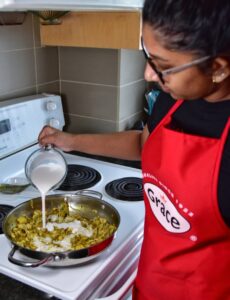 Adding grace Foods Canada organic Coconut Milk to the curry jackfruit